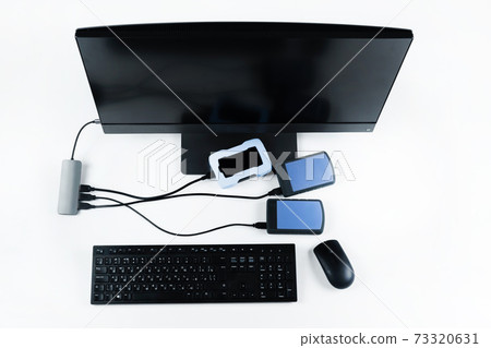 Multiple external hard drives connected to a monoblock on a white background.Computer with hard drive 73320631
