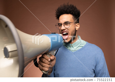 Very irritated young businessman or boss in eyeglasses and casualwear shouting Very irritated young businessman or boss in eyeglasses and casualwear shouting 73322151