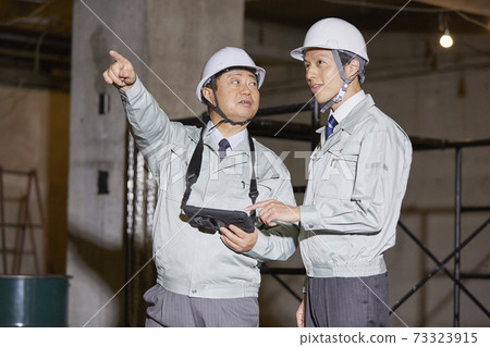 Workers working in the field 73323915