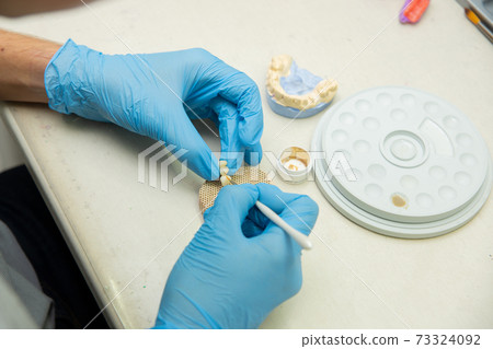 Dental technician work. prosthesis production. teeth prototype construction Dental technician work. prosthesis production. teeth prototype construction 73324092