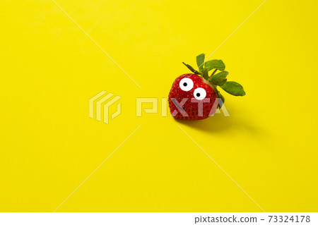 Strawberries on a yellow background. Minimal color still life photography Strawberries on a yellow background. Minimal color still life photography 73324178