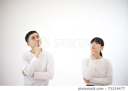 A couple worried while looking up A couple worried while looking up 73324477