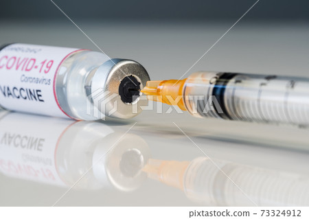 medical syringe needle drawing Coronavirus (Covid-19) vaccine shot from glass of bottle medical syringe needle drawing Coronavirus (Covid-19) vaccine shot from glass of bottle 73324912