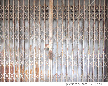 rusty sliding metal door in suburb of Thailand 73327465