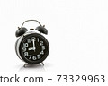 Black old fashion alarm clock. 73329963