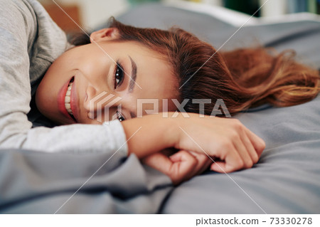 Lazy Asian woman lying on bed Lazy Asian woman lying on bed 73330278