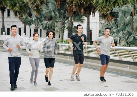 Fit Asian friends jogging together Fit Asian friends jogging together 73331106