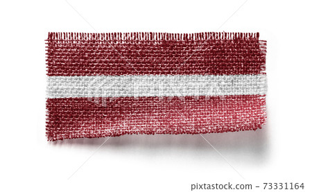 Latvia flag on a piece of cloth on a white background 73331164