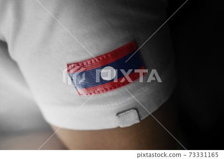 Patch of the national flag of the Laos on a white t-shirt 73331165