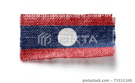 Laos flag on a piece of cloth on a white background 73331169