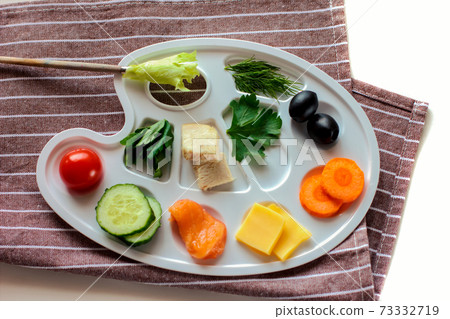 palette with colorful vegetables, fish and greens, creative food design, funny and healthy meal for kids. palette with colorful vegetables, fish and greens, creative food design, funny and healthy meal for kids. 73332719