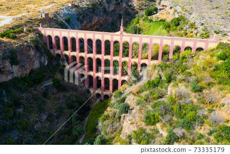 Aqueduct of Eagle over canyon of Barranco de la Coladilla, Nerja, Spain Aqueduct of Eagle over canyon of Barranco de la Coladilla, Nerja, Spain 73335179