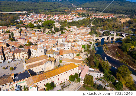 Aerial view of Besalu with Romanesque bridge over Fluvia river, Catalonia, Spain 73335246