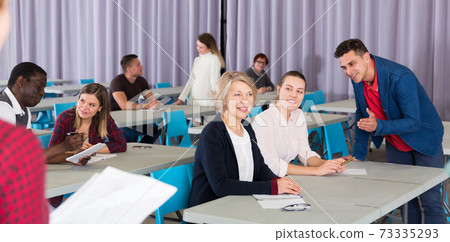 Adult people communicating in classroom Adult people communicating in classroom 73335293