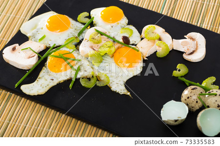 Broken fried quail eggs with mushrooms Broken fried quail eggs with mushrooms 73335583