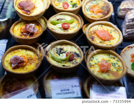 Variety of quiches on French market counter Variety of quiches on French market counter 73335994