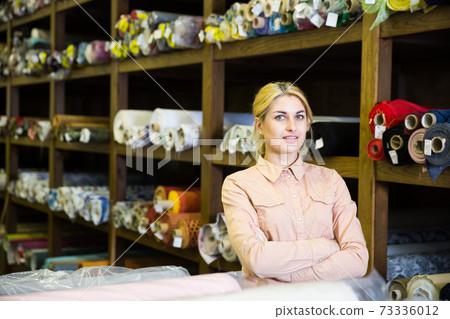 Confident young woman in textiles store Confident young woman in textiles store 73336012