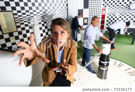 Emotional girl in quest room with other multiracial people Emotional girl in quest room with other multiracial people 73336177