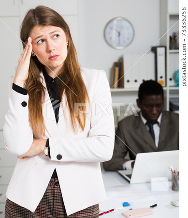 Frustrated woman at office Frustrated woman at office 73336258