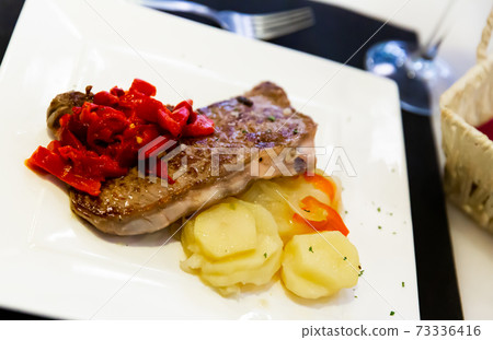 Steak entrecote of beef with fried potatoes and paprika 73336416
