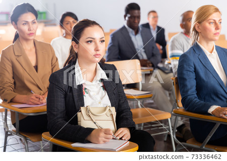 Female entrepreneur sitting in conference room at business training Female entrepreneur sitting in conference room at business training 73336462
