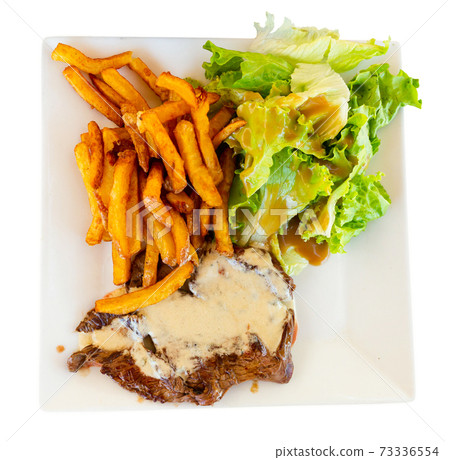 Beef steak with Roquefort sauce served with baked potatoes Beef steak with Roquefort sauce served with baked potatoes 73336554