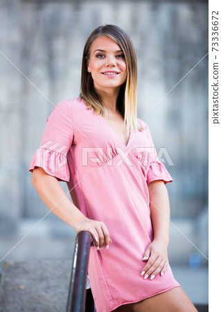 Female standing on handrail of stairs at the street in Barcelona 73336672