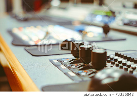 controller machine and man hand editing or adjusting color on digital video 73336848