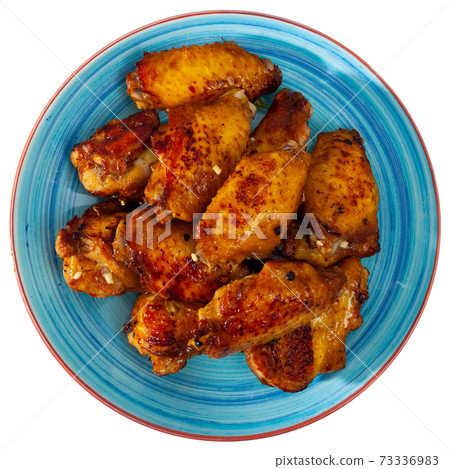 Tasty crispy grilled chicken wings on plate Tasty crispy grilled chicken wings on plate 73336983