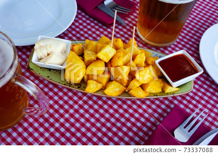 Spicy fried potatoes Patatas bravas with sauces 73337088