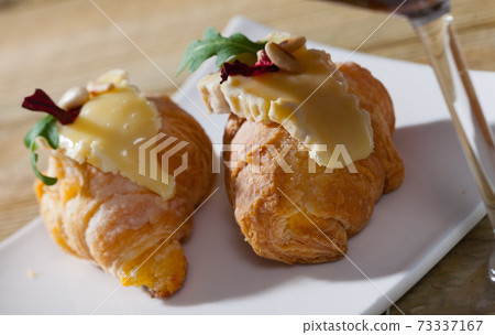 Mini croissant with Camembert, arugula Mini croissant with Camembert, arugula 73337167