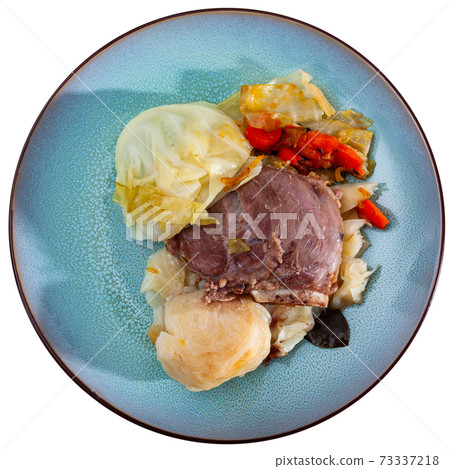Image of baked pork cheeks with cabbage and carrot at plate Image of baked pork cheeks with cabbage and carrot at plate 73337218
