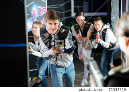 Cheerful guy during lasertag game 73337219