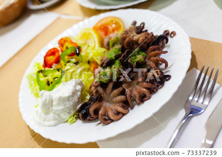 Baby octopus with salad 73337239