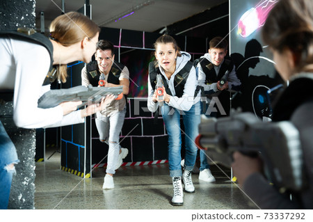Young people having fun on lasertag arena Young people having fun on lasertag arena 73337292