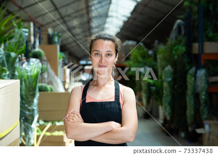 Garden store worker posing at shopping room Garden store worker posing at shopping room 73337438