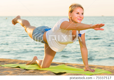 Portrait of sportswoman which is doing excercises on endurance Portrait of sportswoman which is doing excercises on endurance 73337517