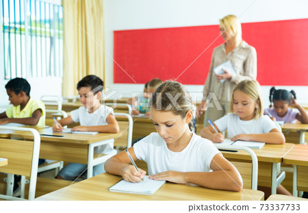 Group of focused kids working at class Group of focused kids working at class 73337733