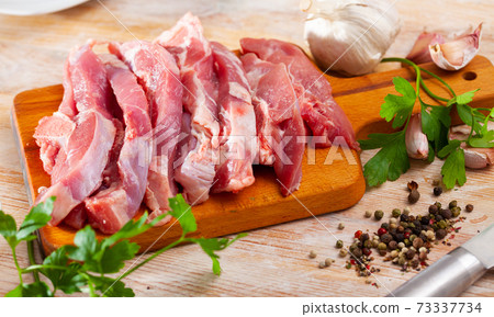 Preparation of raw turkey thigh with parsley and garlic Preparation of raw turkey thigh with parsley and garlic 73337734