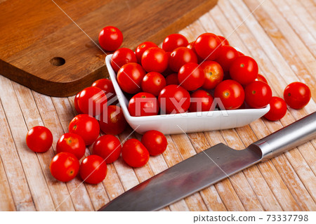 Closeup of ripe red cherry tomatoes on wooden table 73337798
