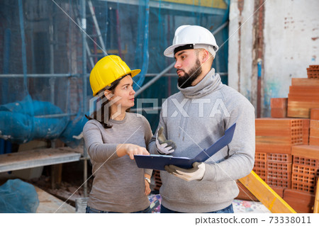 Engineers inspecting process of building overhaul 73338011