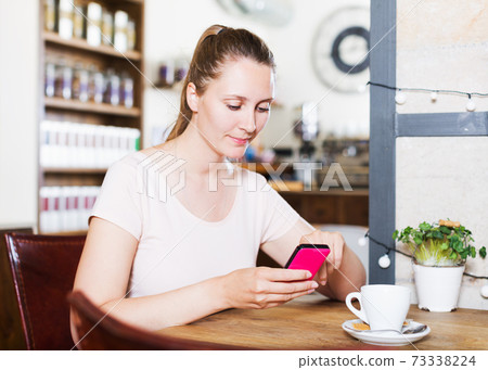 Girl ordered coffee and chatting in the phone 73338224