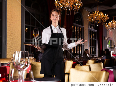 Portrait of smiling waitress Portrait of smiling waitress 73338312
