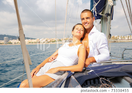 Couple sailing on yacht along Spain 73338455
