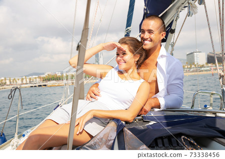 Couple sailing on yacht along Spain 73338456