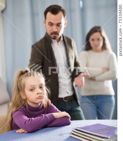 Adult parents lecturing girl for bad behavior Adult parents lecturing girl for bad behavior 73338480
