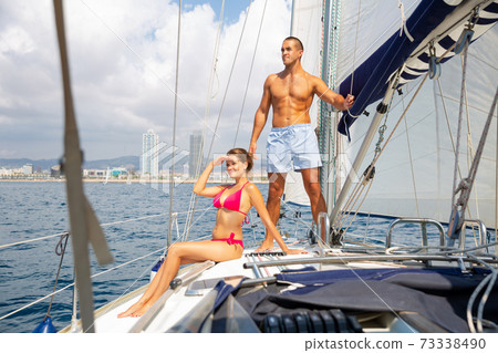 Couple sailing on yacht along Spain Couple sailing on yacht along Spain 73338490