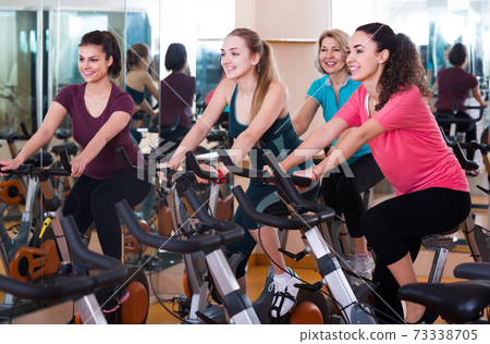 Elderly and young women working out hard in sport club Elderly and young women working out hard in sport club 73338705