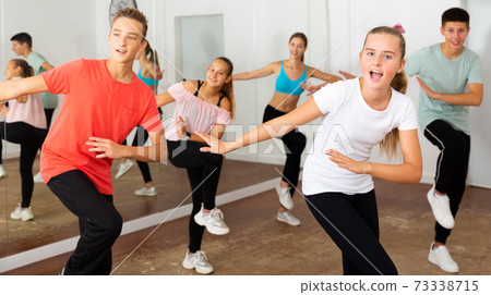 Teenage dancers practicing in dance studio Teenage dancers practicing in dance studio 73338715