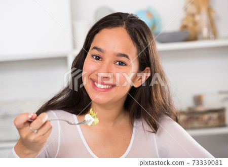 Smiling girl eating tasty sala Smiling girl eating tasty sala 73339081